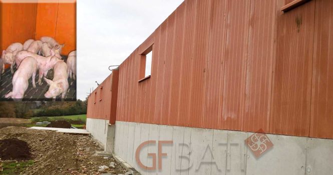 construction porcherie avec murs de soutènement en béton et élévation en brique monolithe